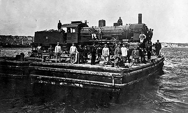 historical photo of workers with a train