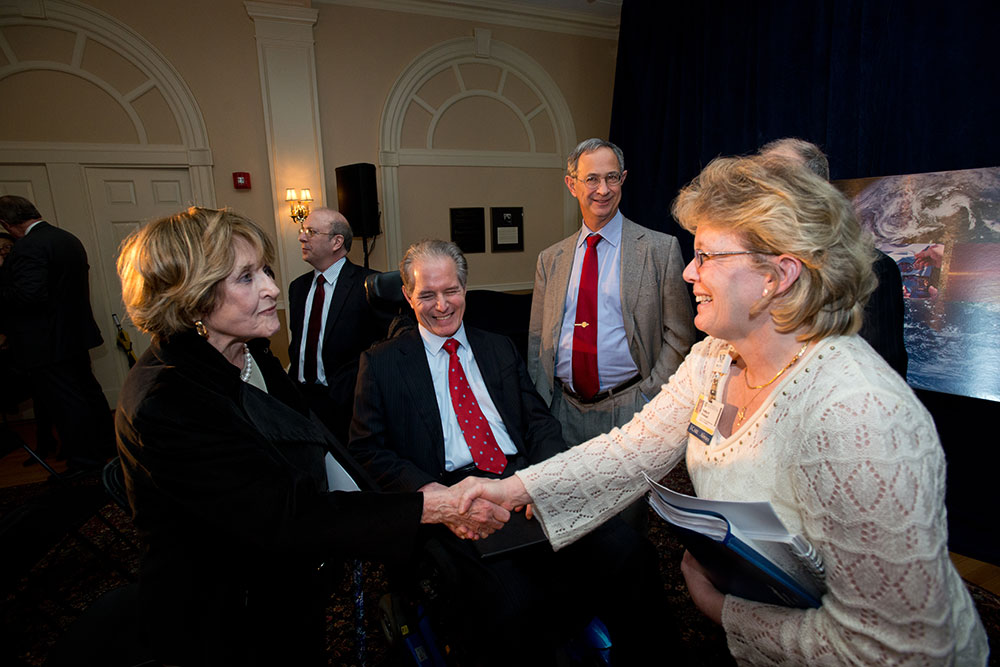 Louise Slaughter shaking hands in a crowd of people
