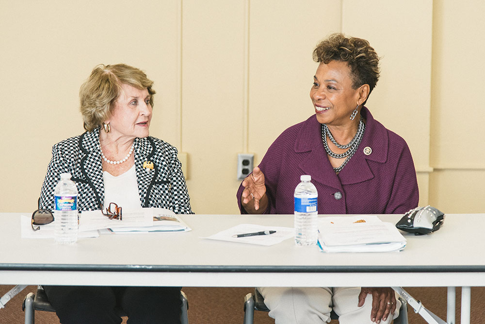 Louise Slaughter speaking at a table with Barbara Lee