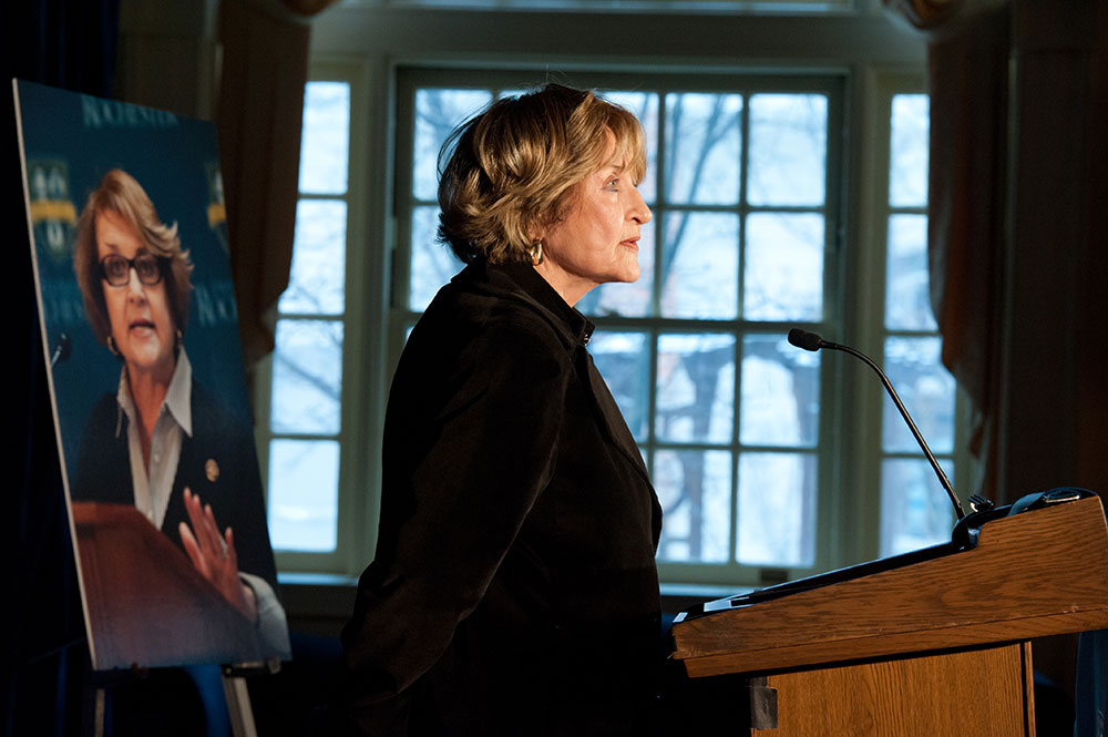 Louise Slaughter, in profile, in front of a window