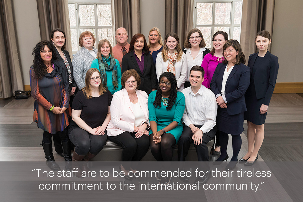 Group portrait with the quote, “The staff are to be commended for their tireless commitment to the international community.” 