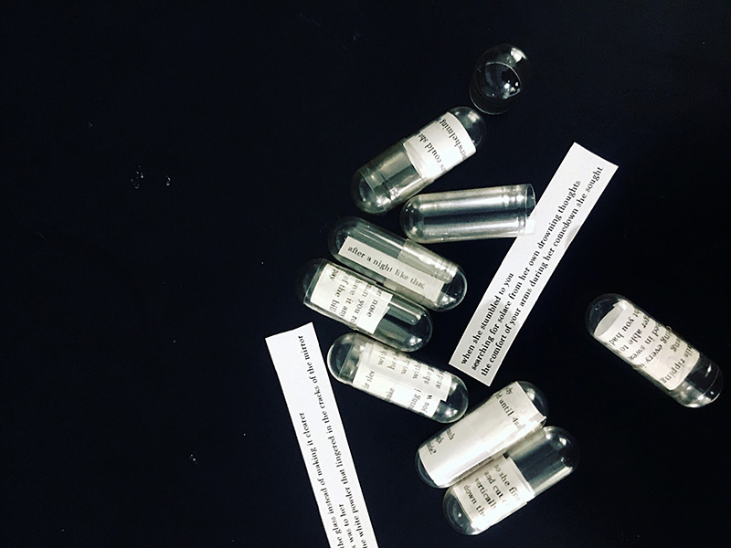 photograph of vials with slips of paper inside