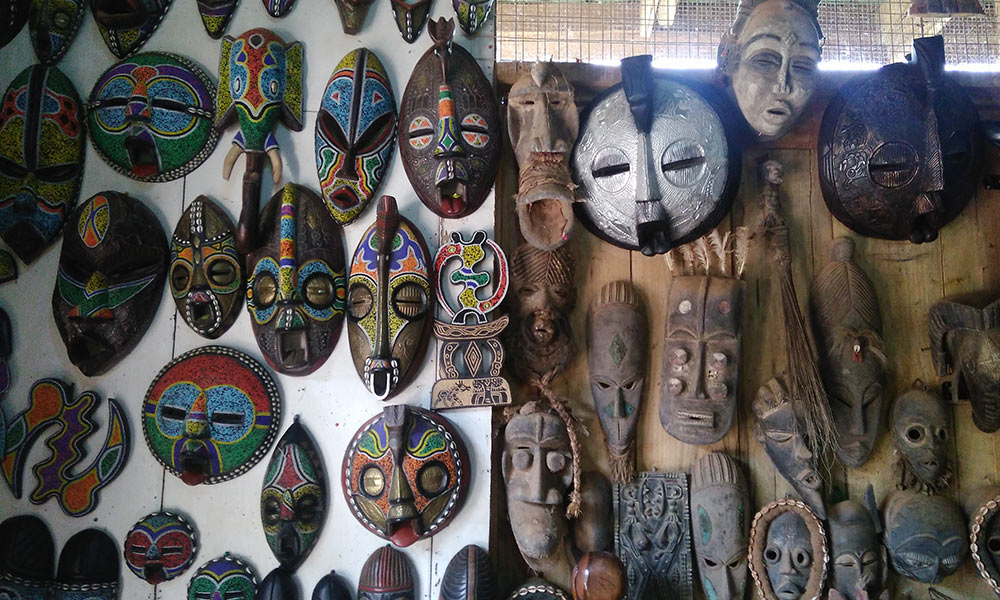 African masks hanging on a wall in Ghana