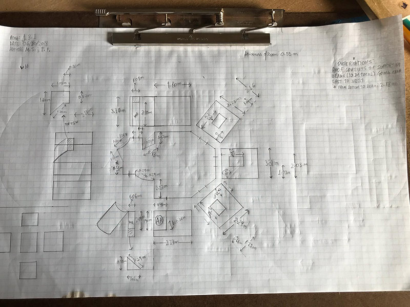clipboard with sketches and dimensions of rooms