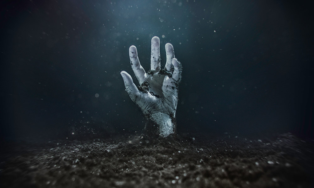 hand rising out of the grave - a trope in horror films.