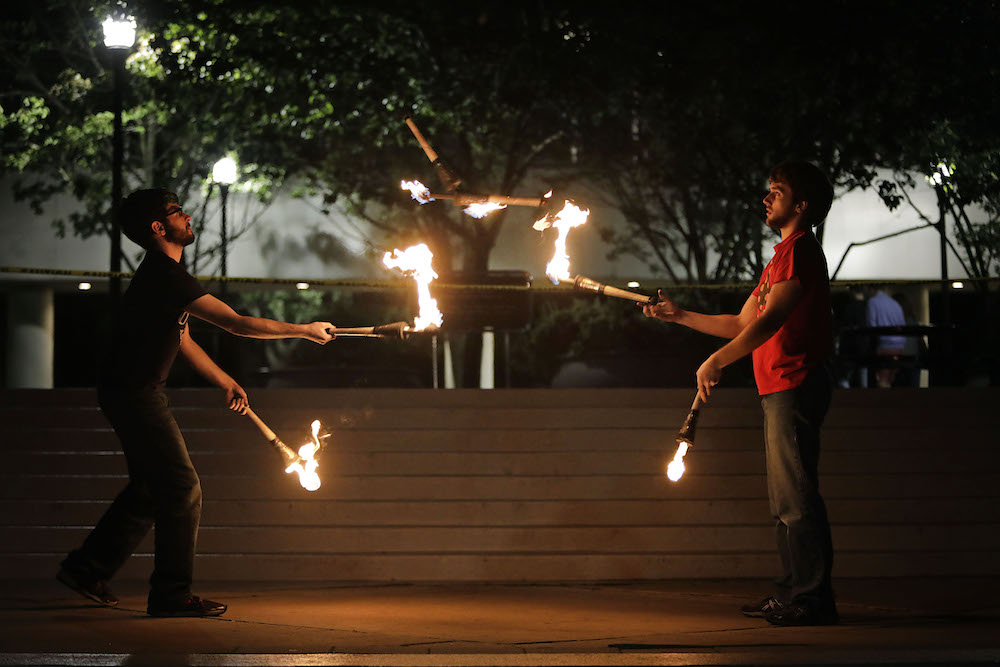 two students juggle fire