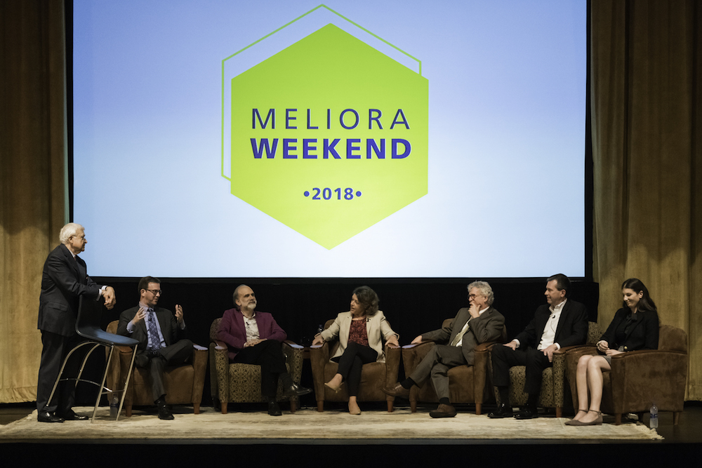 several panelists sitting on a stage