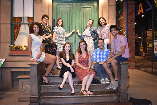 group photo of the Mellon Fellows in front of the Seseme Street set at the Strong Museum of Play