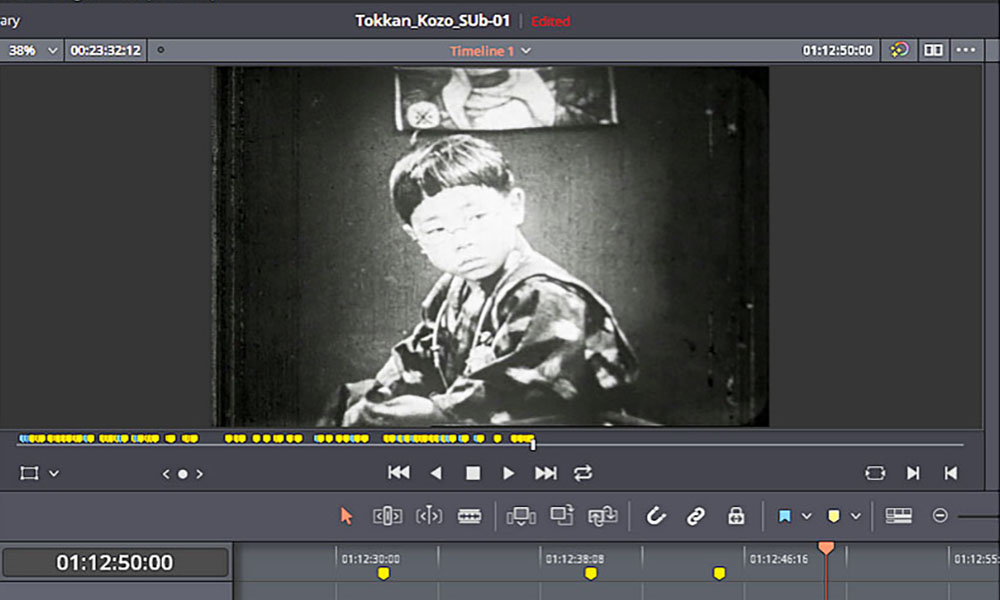 black-and-white movie still of a small boy is seen in the surrounding software interface of a film editing program.