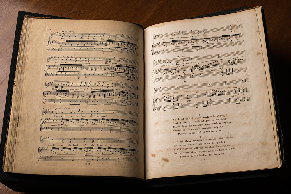 a book open to a double spread of sheet music