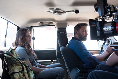 Two actors -- Maddy Wary and Ben Affleck -- filming a scene in a car. 