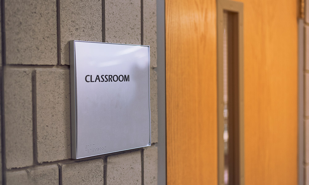 a sign reads CLASSROOM outside a door.
