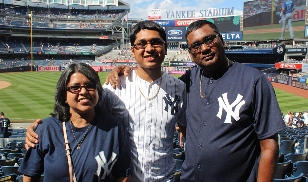 family posing at a baseball game