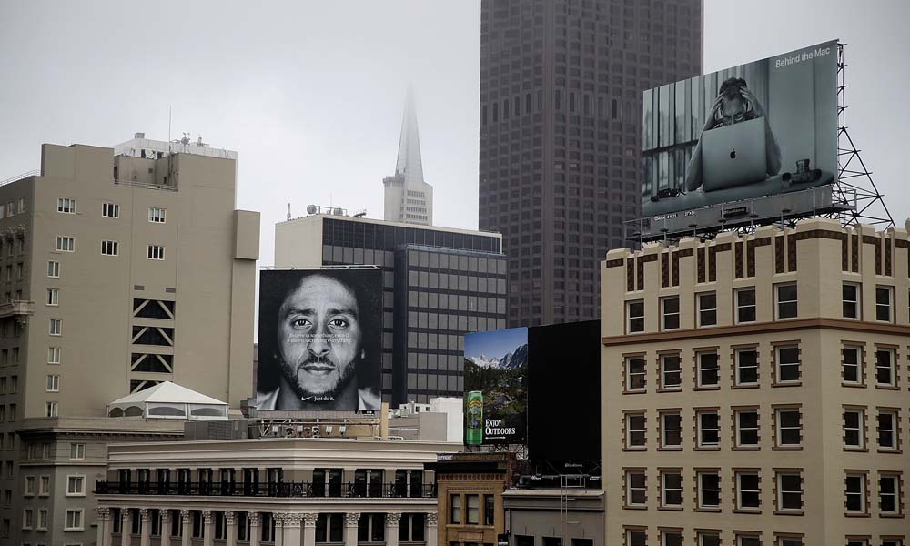 Billboard ad by Nike featuring Colin Kaepernick displayed prominently on the roof of the Nike Store in San Francisco.