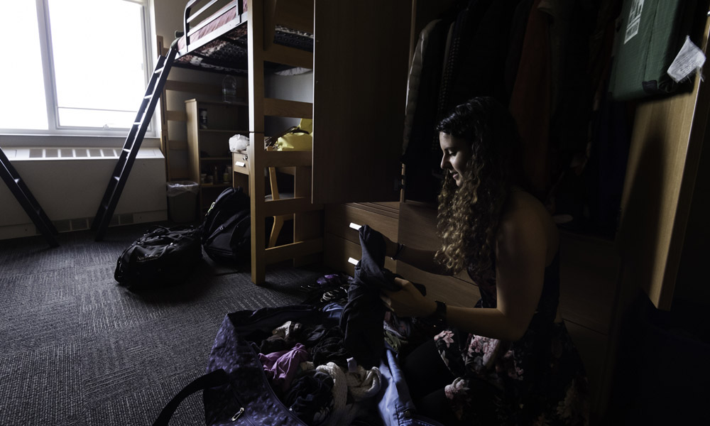 student sitting her her dorm room
