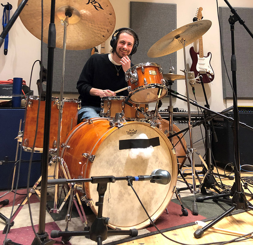 musician playing the drums in a recording studio.