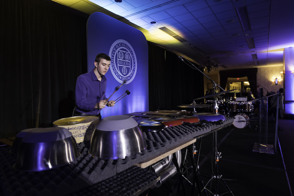 student plays percussion