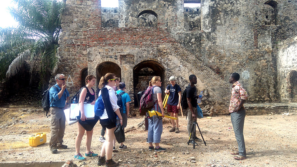 group of students gather outside a fort