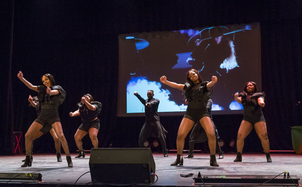 dancers on a stage performing a step show