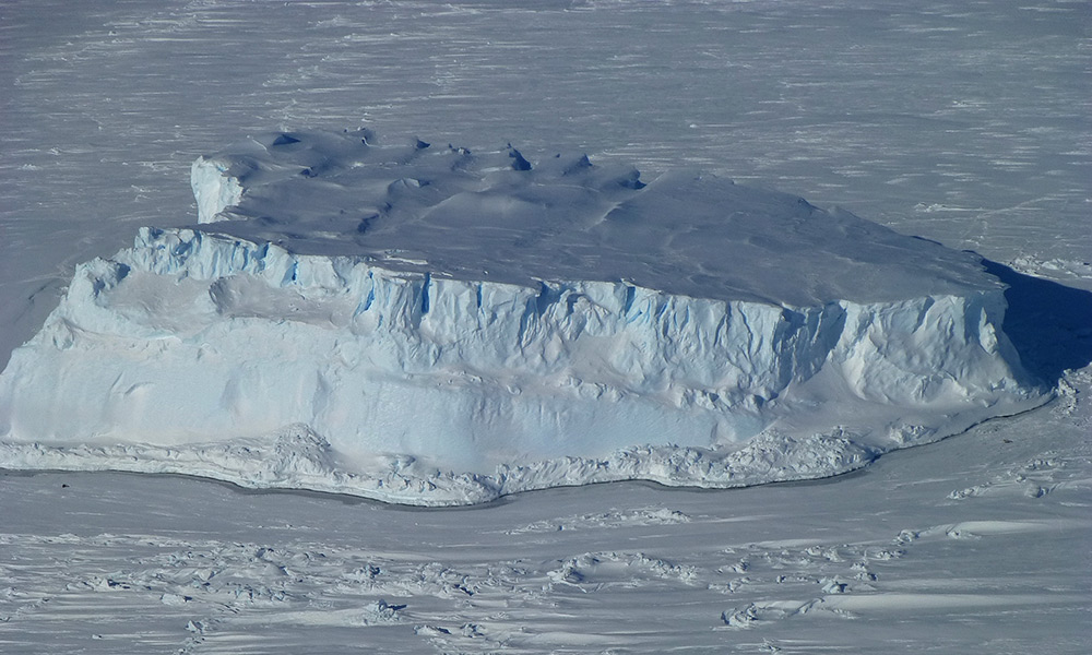 a large iceberg stuck in sea ice.