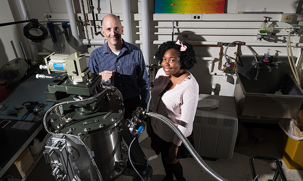 Diarra Bell ’20 standing with Craig McMurtry, senior research engineer at the infrared research laboratory, in the lab.