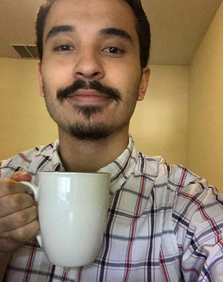 selfie of Cez Garcia, drinking a cup of coffee