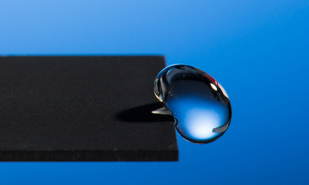 close-up of water droplet on edge of metal surface
