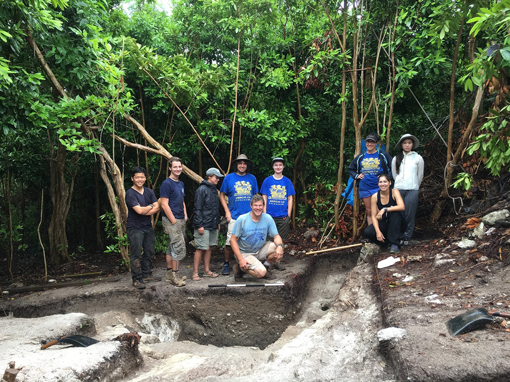 a group photo around a excavation site in Bermuda.