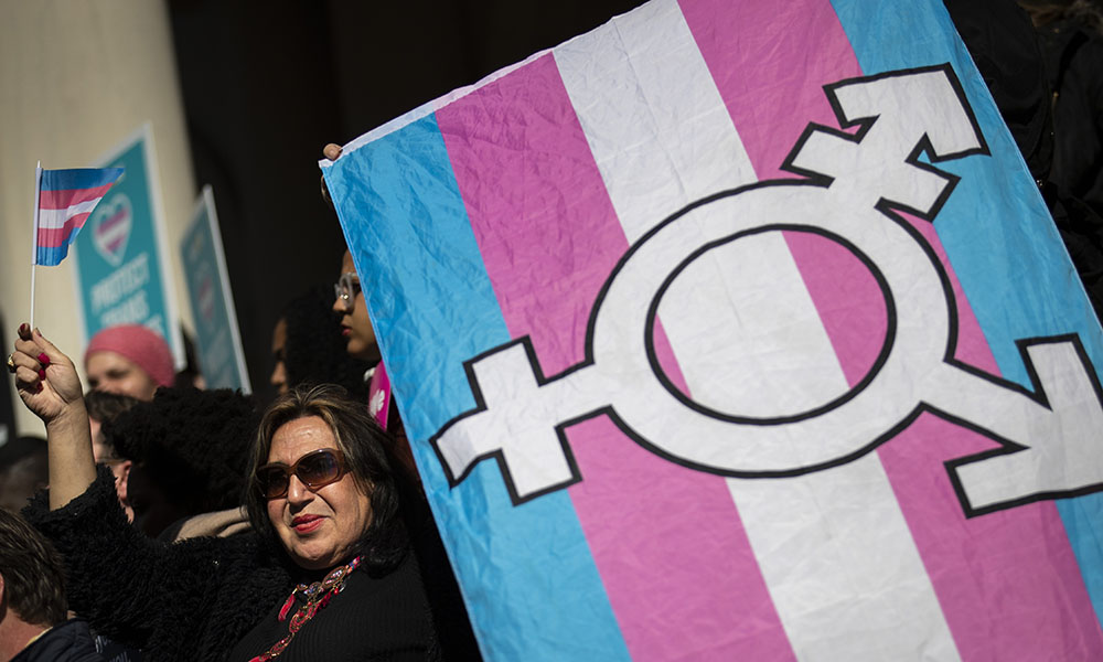 protester holding a transgender pride flag