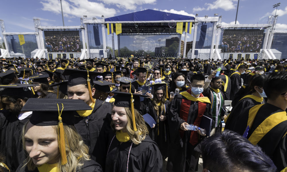 Members of the Class of 2022 in front of the stage in Fauver Stadium.