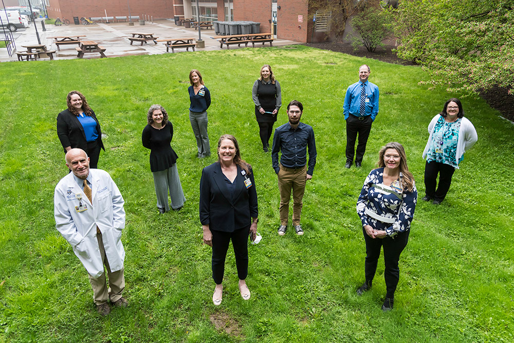 group portrait of the SMH Infection Prevention Team standing socially distanced outdoors.