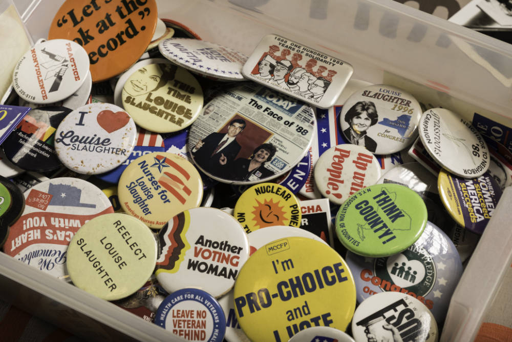 Box of various campaign buttons from Louise Slaughter's political career.