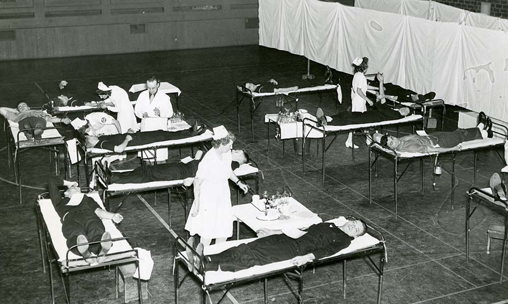 Nurses in Palestra attend to students on cots at blood drive.