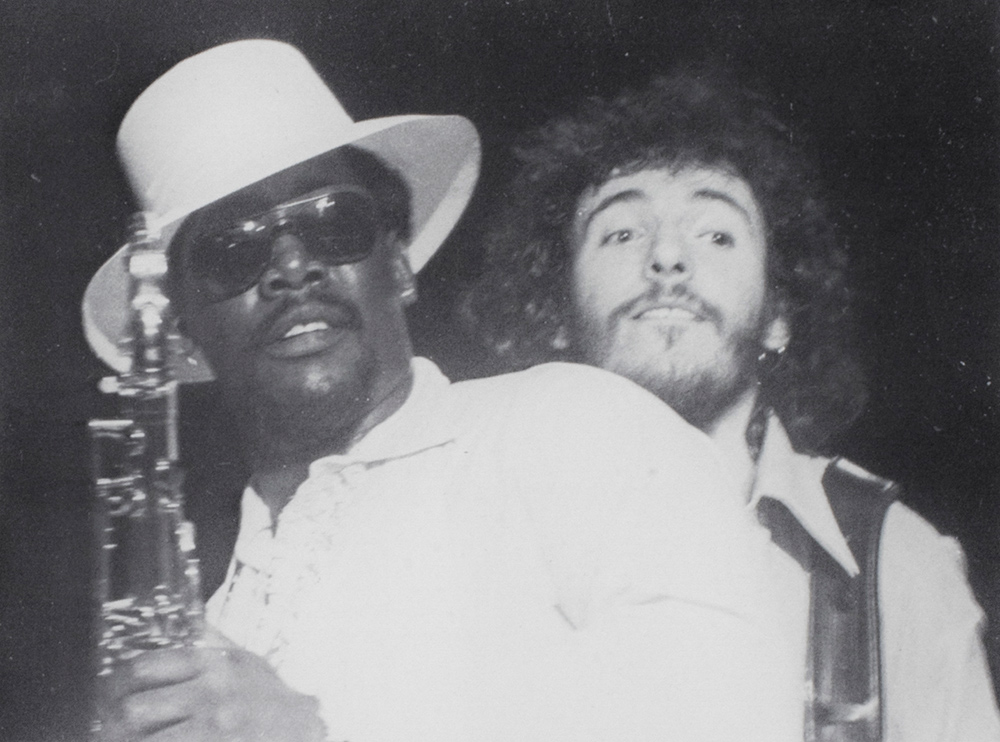archival concert photo, close-up of Clarence Clemmons and Bruce Springsteen.