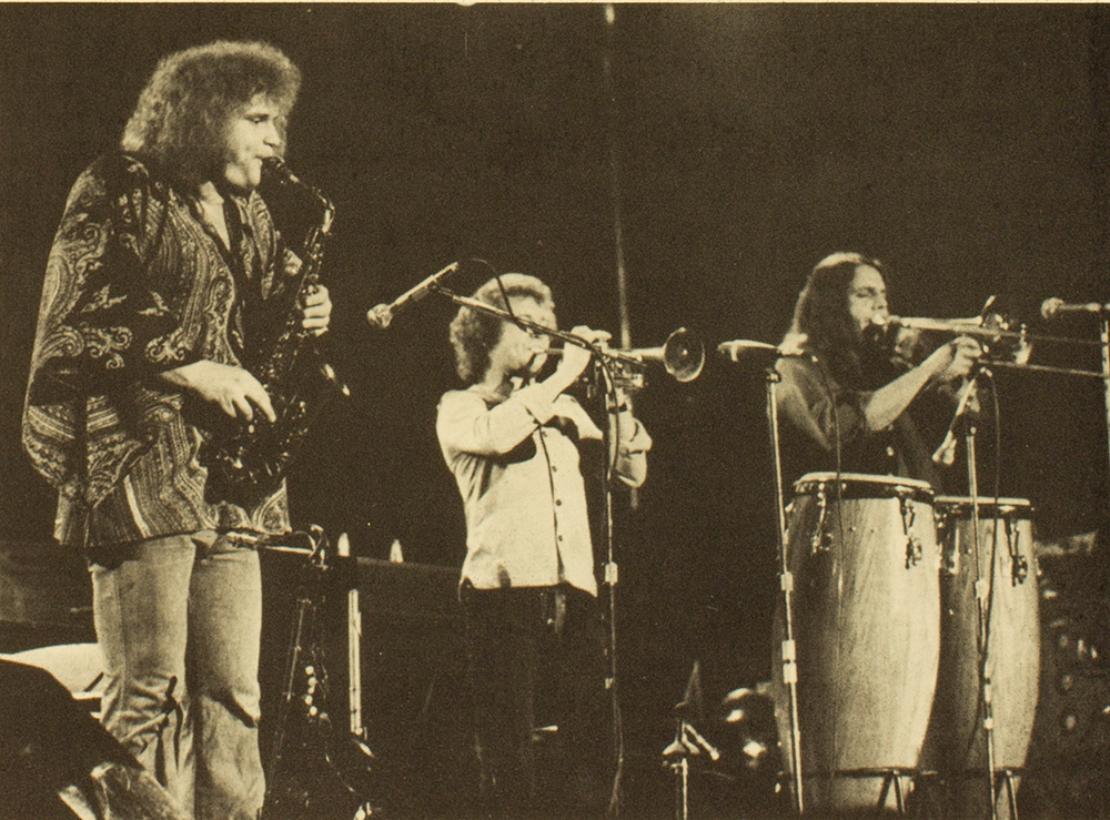 concert photo of Blood Sweat and Tears, musicians playing saxophone, trumpet, and bongos..