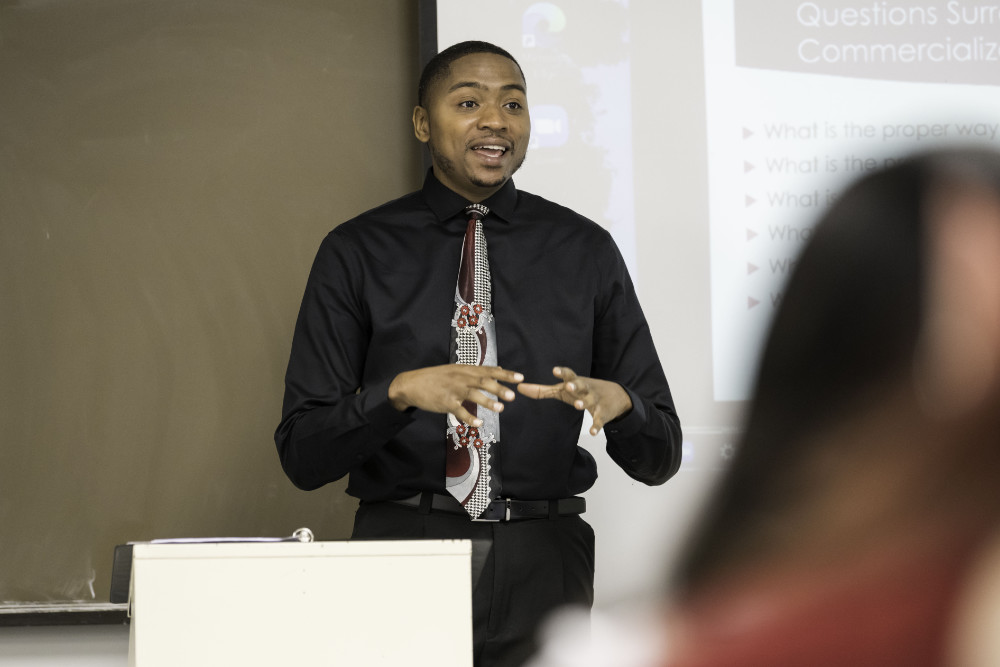Cory Hunter at the front of a classroom teaching.