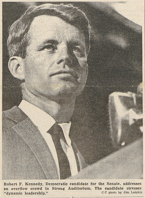 newspaper clipping features a photo of Robert Kennedy with the caption ROBERT KENNEDY, DEMOCRACTIC CANDIDATE FOR THE SENATE, ADDRESSES AN OVERFLOW CROWD IN STRONG AUDITORIUM.