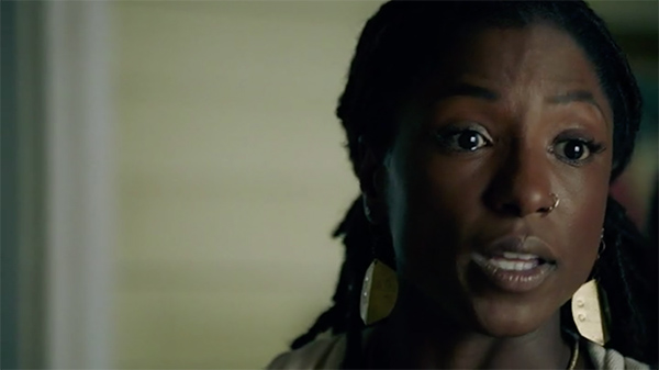 Close-up of Black actress Rutina Wesley, with tears in her eyes.