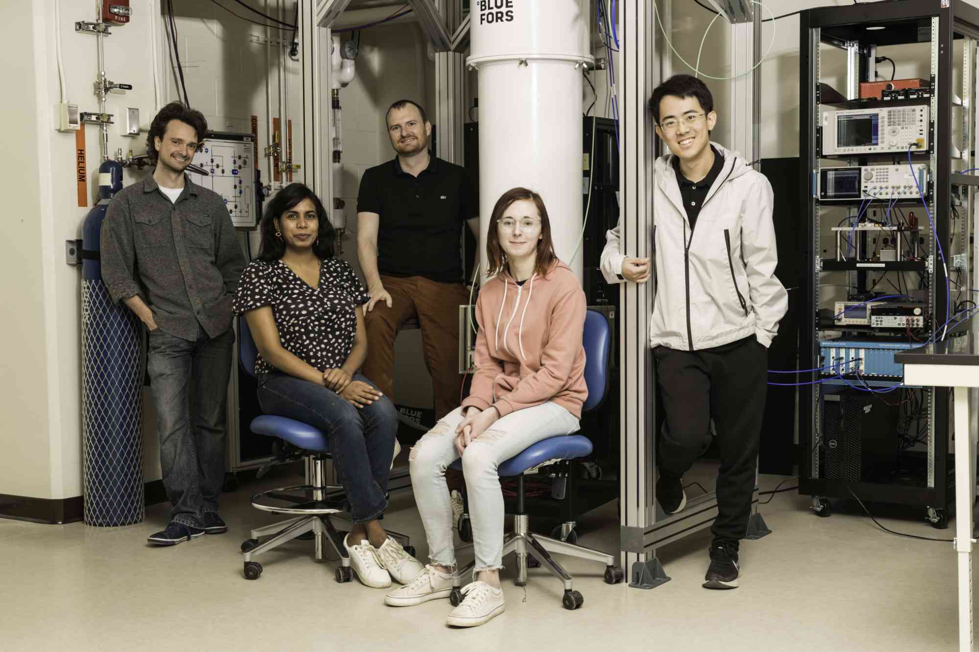 University of Rochester researchers pose for a group photo in a lab used to create superconducting circuits.