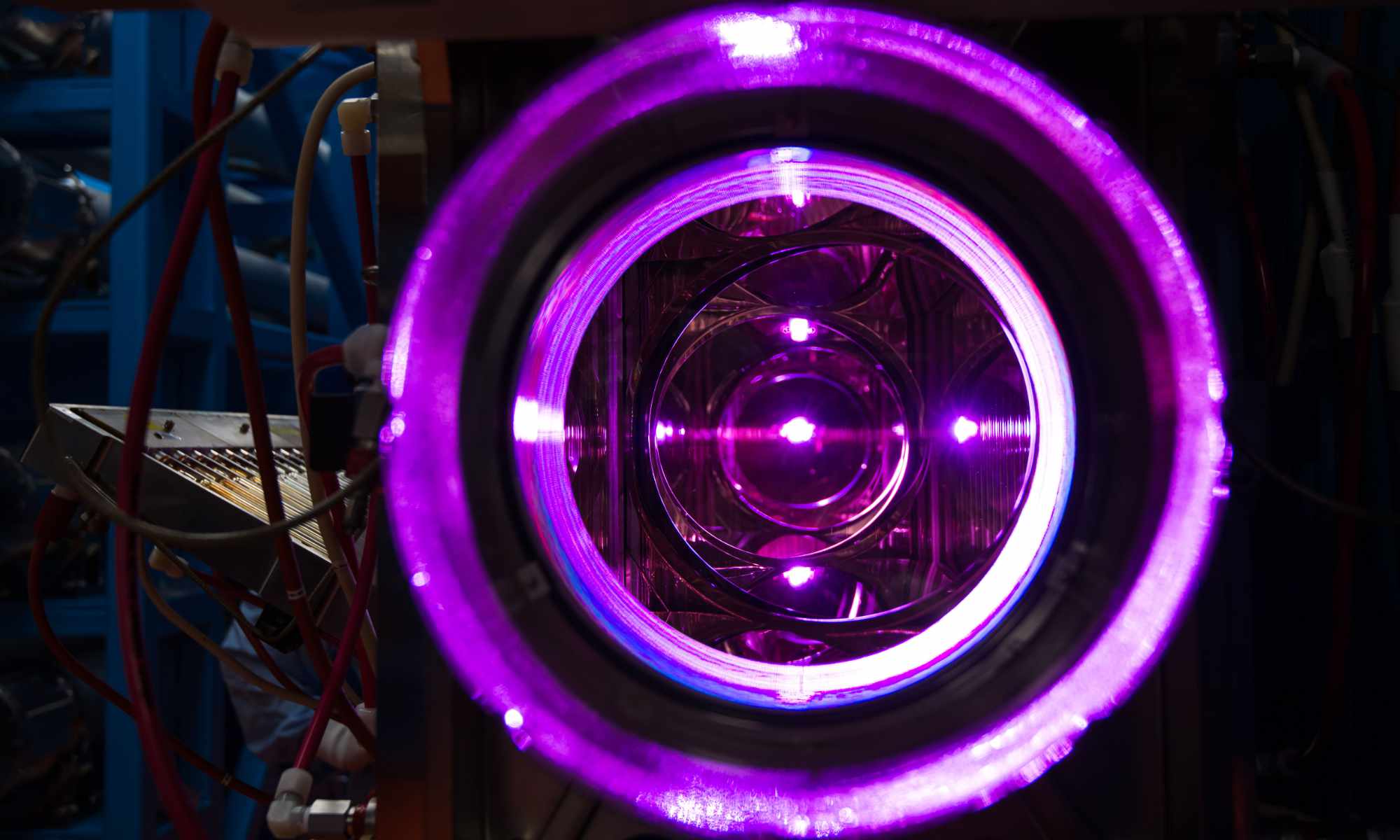 View through the OMEGA laser's 20-cm disk amplifiers shows several electric purple-colored concentric circles.