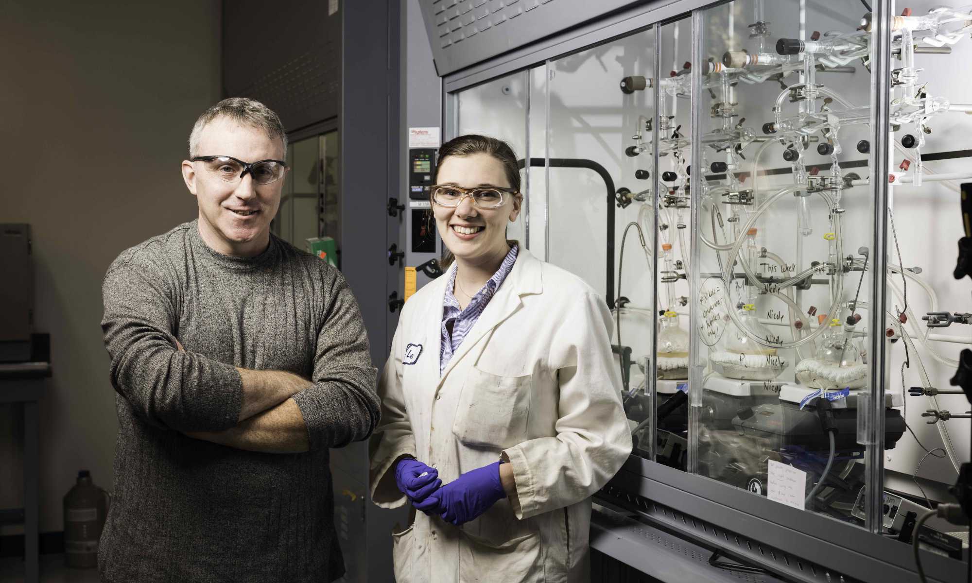 Todd Krauss and graduate student Leah Frenette in a chemistry lab.