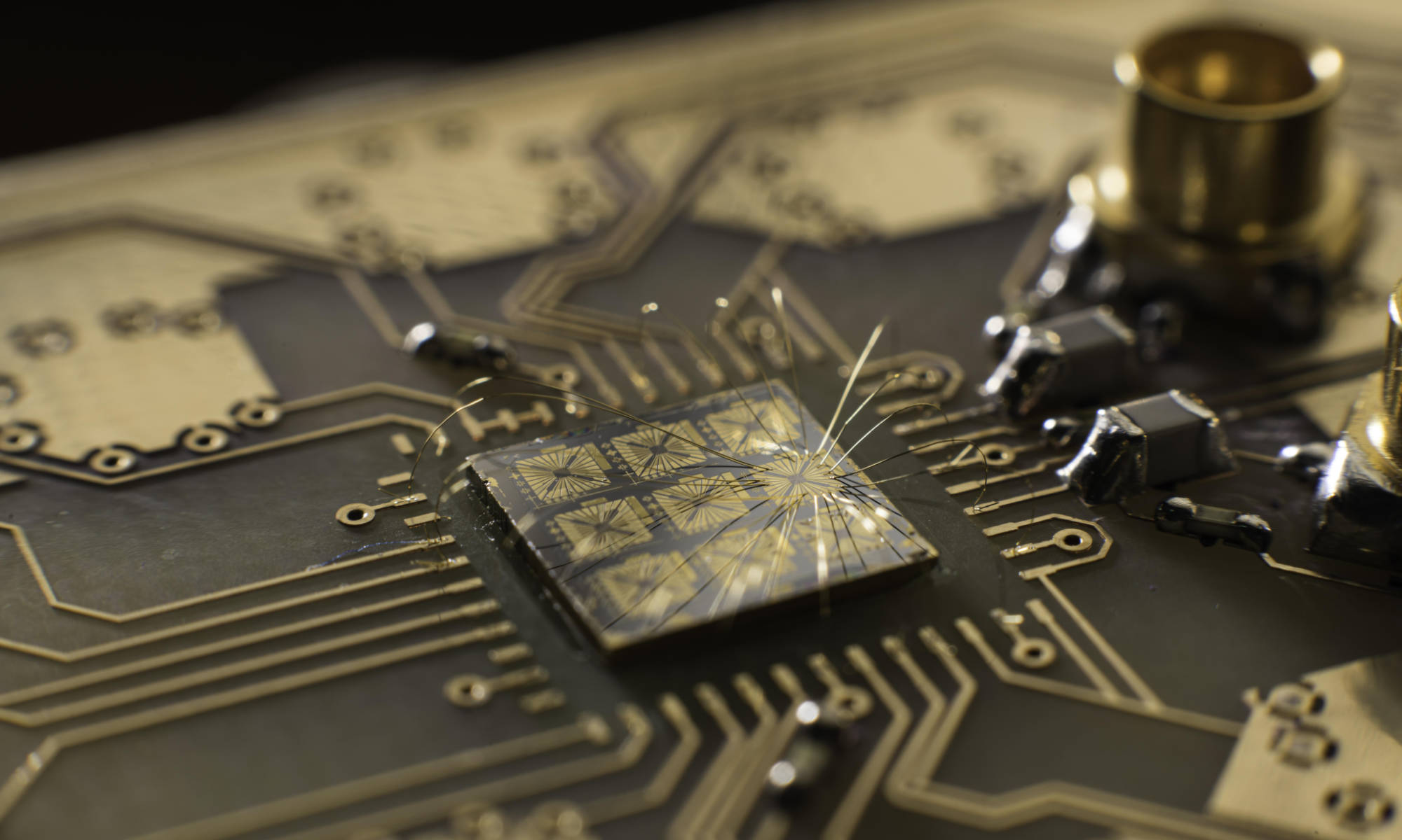 A quantum processor semiconductor chip connected to a circuit board.