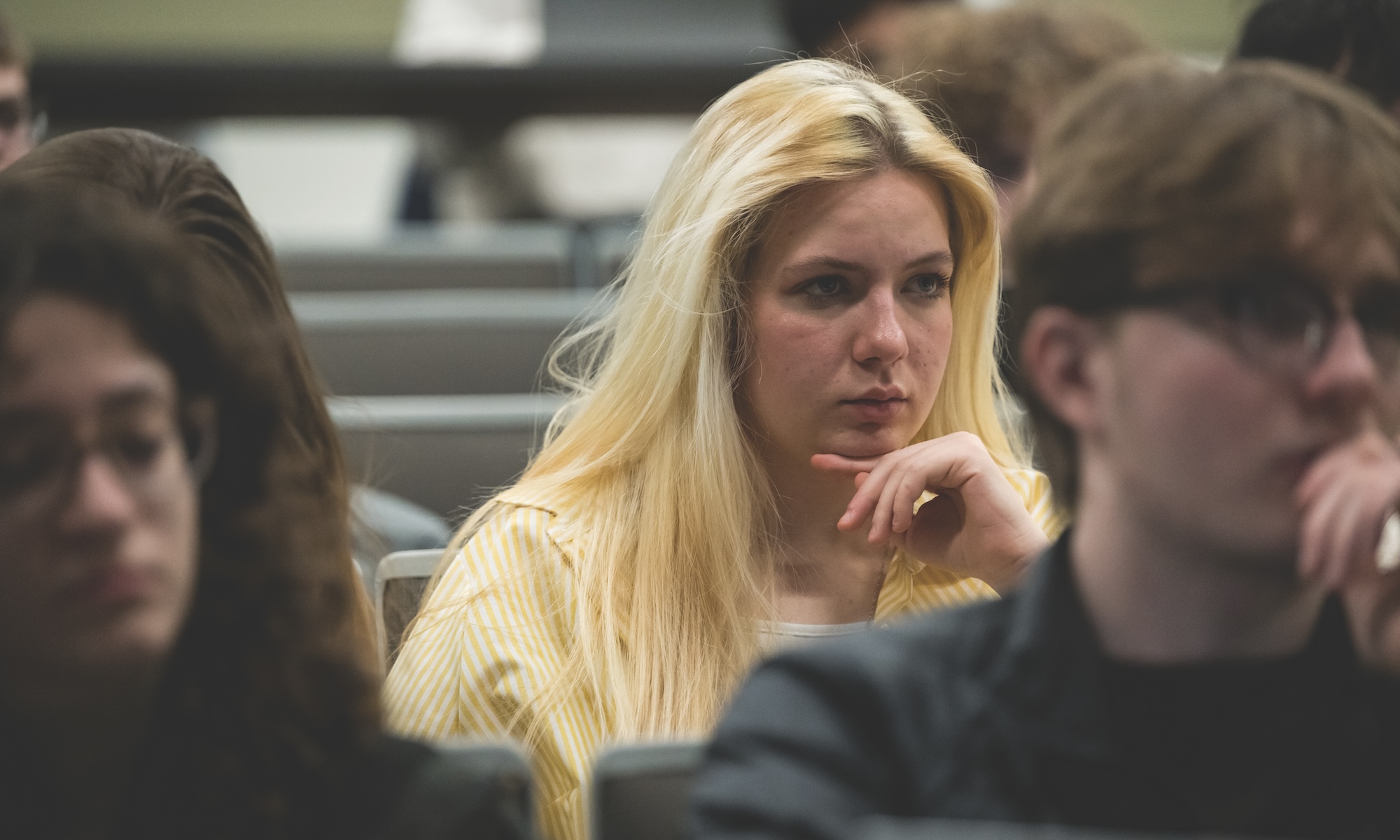 Close-up of face of Yushchenko as she sits in class in lecture hall.