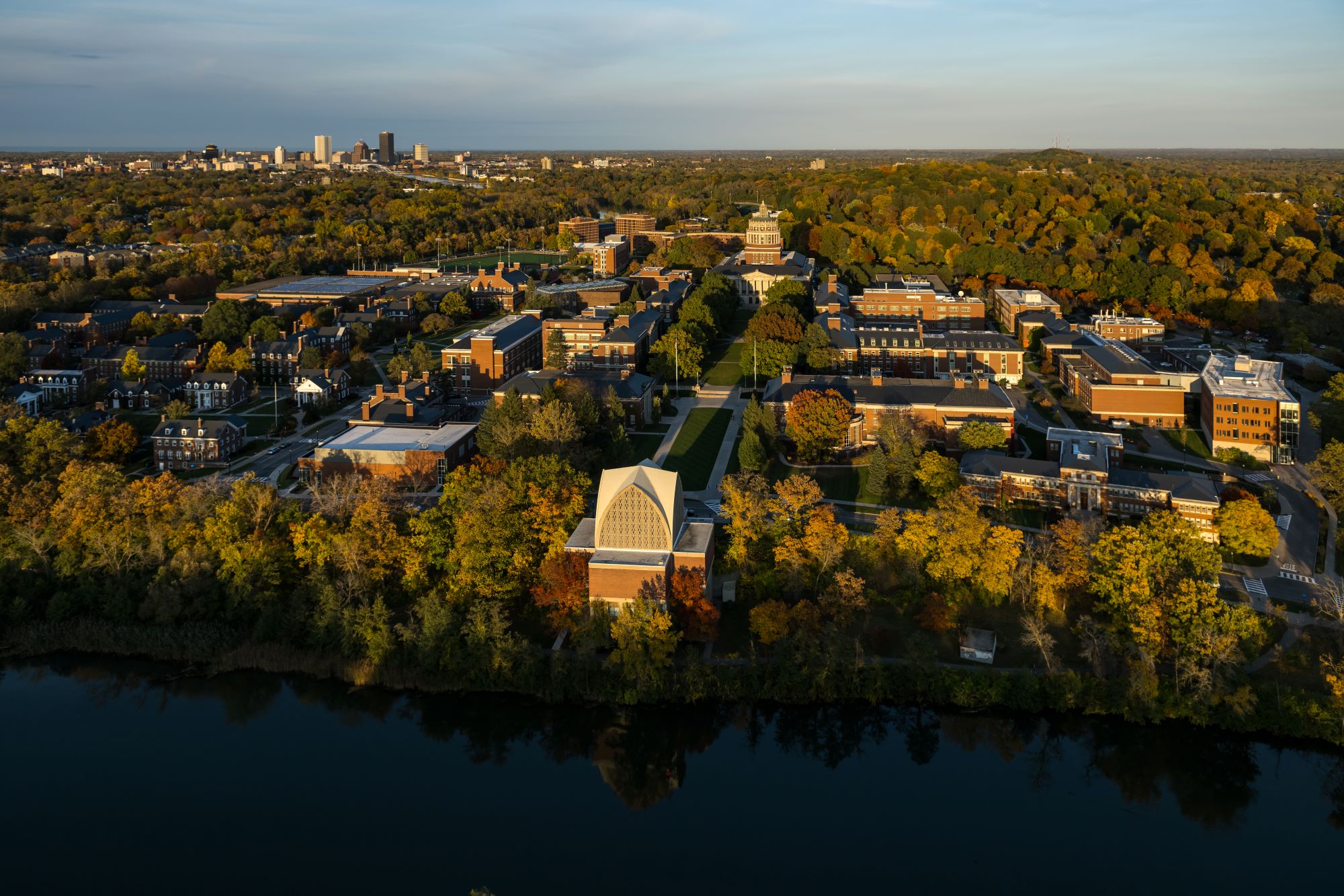 Aerial view of the University of Rochester's River Campus with the Interfaith Chapel in the foreground during the fall.