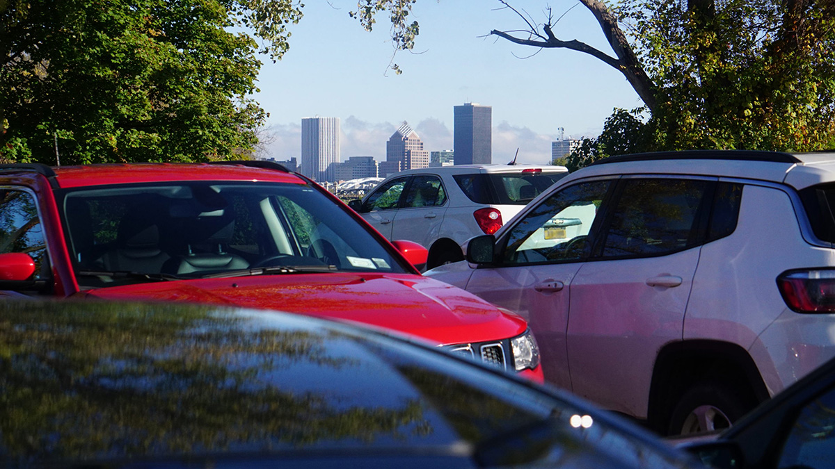 parked cars with Rochester, NY skyline in background.