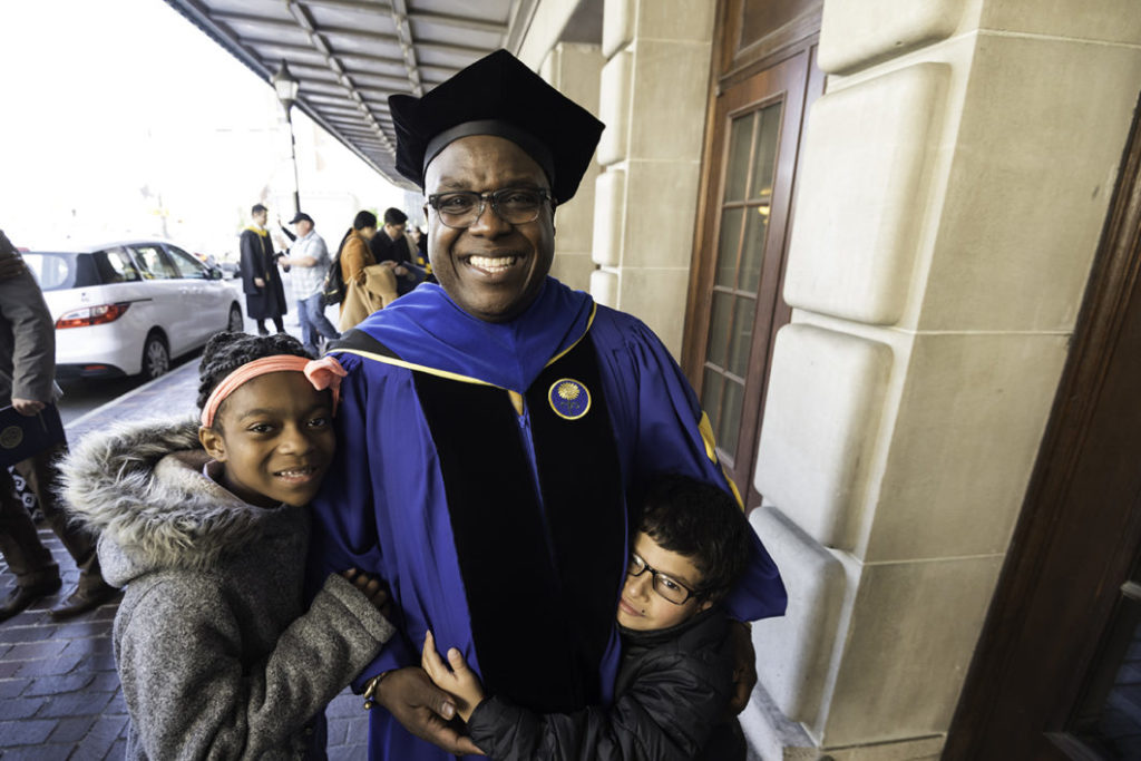 A University of Rochester doctoral graduate with his children