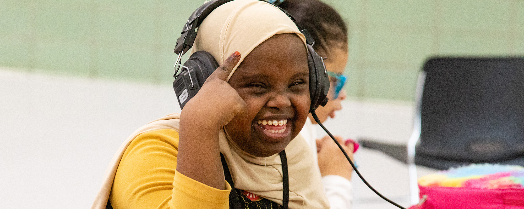 Young woman with a big smile wearing headphones